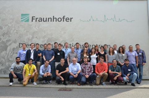 Gruppenbild der einunddreißig Teilnehmer der Sommerschule vor dem Fraunhofer IWS Logo