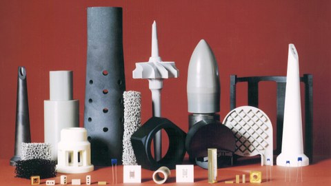 Various kinds of ceramic bodys, with different shape and size, are arranged to form a "ceramic skyline" in front of a red background.