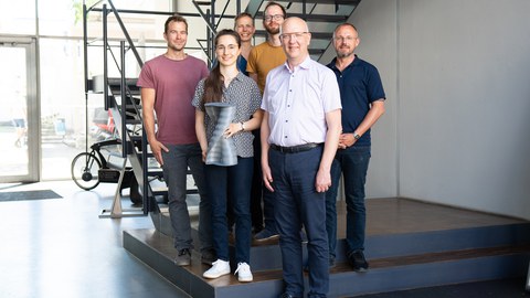 Group photo: People standing frontally, smiling at the camera.