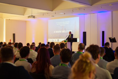 Prof. Gude auf der Bühne vor den Teilnehmern des Leichtbausymposiums.