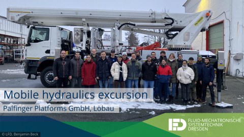 Excursion group on the Palfinger factory premises in Löbau testing the aerial work platforms