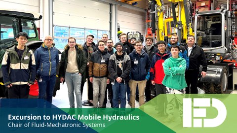 Group Photo in Front of the Demonstrators at the HYDAC Mobilhydraulik Test Field