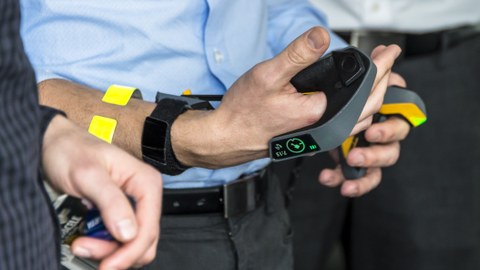 a Person is holding a newly invented remote system for controlling construction machines