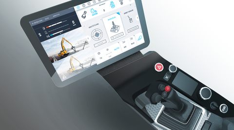 Draufsicht auf eine neuartige Steuerkonsole für Baumaschinen, von links nach rechts sieht man ein Display mit verschiedenen angezeigten Funktionen, einen roten und schwarzen Knopf, einen Joystick mit Steuerkreuz, einen Mode-Schalter sowie Start-/Stop-Knopf und eine Armstütze.