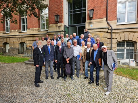 Gruppe älterer Herren vor Haupteingang des ZEUNER-Baus