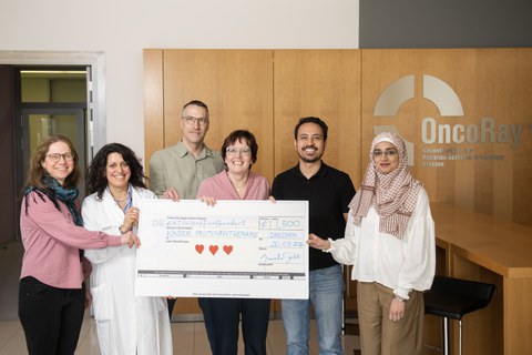 Deputy Head of Chair presenting the donation at the clinic, alongside Prof. Mechthild Krause (Co-Director of the Department of Radiotherapy and Radiation Oncology) & Dr. Chiara Valentini (Senior Physician at the Department of Pediatric Oncology)