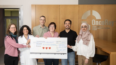 Deputy Head of Chair presenting the donation at the clinic, alongside Prof. Mechthild Krause (Co-Director of the Department of Radiotherapy and Radiation Oncology) & Dr. Chiara Valentini (Senior Physician at the Department of Pediatric Oncology)