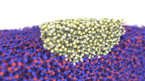 Auf dem Foto sieht man im unteren Bereich eine Vielzahl von blau-roten Kugeln, darüber mittig eine Vielzahl von gelb-weißen Kugeln. Sie symbolisieren einen Ausschnitt einer molekulardynamischen Simulation von amorphem Siliciumdioxid.