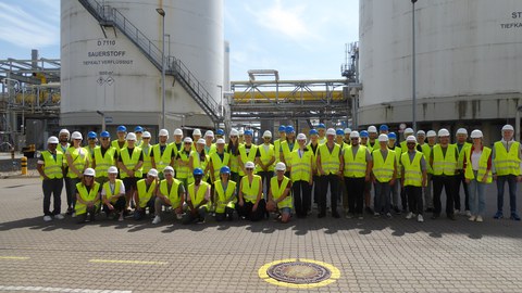 Group photo of the ECC participants in yellow safety vests with helmets.