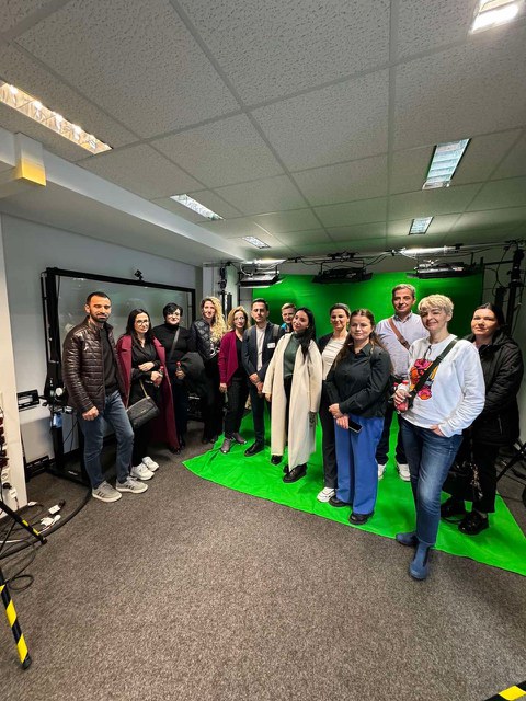 Group picture in a studio with green screen.