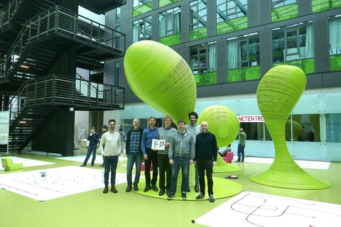 Group photo in the green foyer of the Andreas Pfitzmann Building (APB). 