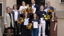group photo of award winners with prorector in front of the rectorate building