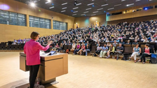 Professor Dr Roswitha Böhm in front of the packed Audimax
