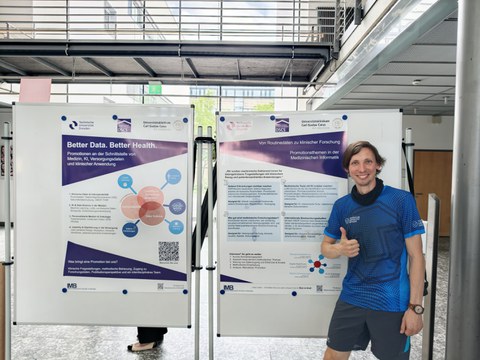 Dr. Markus Wolfien beim Austausch zu Forschung und Promotion vor den Postern der Professur für Medizinische Informatik beim Dies Academicus 2026.