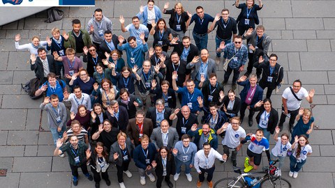 viele Menschen winkend von oben fotografiert