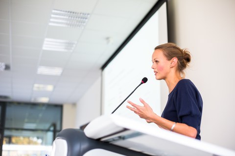 Junge Wissenschaftlerin hält einen Vortrag