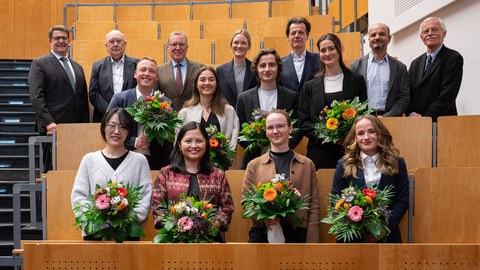 Im Vordergrund: acht Nachwuchsforschende erhalten den Carl Gustav Carus-Förderpreis. Im Hintergrund die Vertreterinnen und Vertreter der Medizinischen Fakultät, des Vorstands vom Uniklinikum und edr Stiftung Hochschulmedizin.
