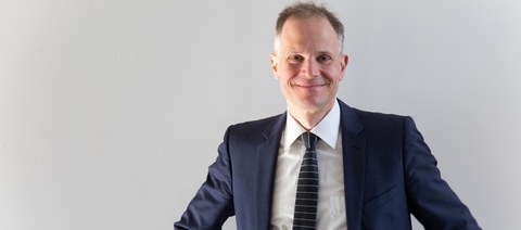 Foto vom Jochen Schmitt: Eine Person schaut lächelnd in die Kamera.