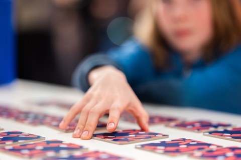 A child exploring the various cards to learn the names of bacteria
