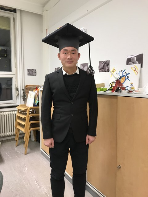Guocan Jiang with doctors hat
