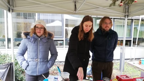 Mitglieder der Arbeitsgruppe stehen am Verkaufsstand