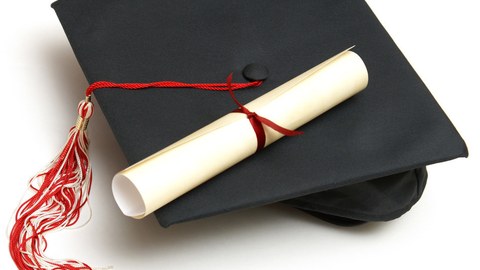 The picture shows a diploma certificate and a PhD hat
