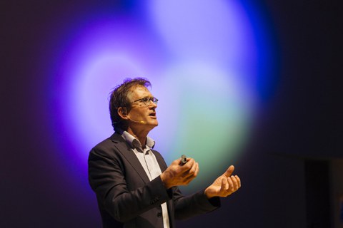 Ben Feringa bei seinem Vortrag vor erleuchteter Kulisse