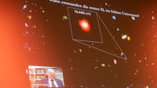 Reinhard Genzel und seine Powerpoint auf der die Frage geklärt wird, wann die ersten Schwarzen Löcher im frühen Universum entstanden sind.