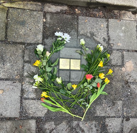 Zu sehen sind die Stolpersteine von Dr. Walter Blumenfeld und Magrgarete Blumendeld. Um die Steine  sind Schnittblumen gelegt.