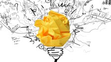 Illustration einer Glühbirne, deren Birne ein gelbes Papierschnipsel ist