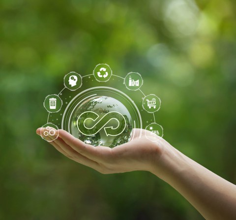 Circular economy concept. Hand-holding crystal globe with a circular economy icon around it. Ideas for future growth of business and design to reuse and renewable material resources.reuse .renewable 