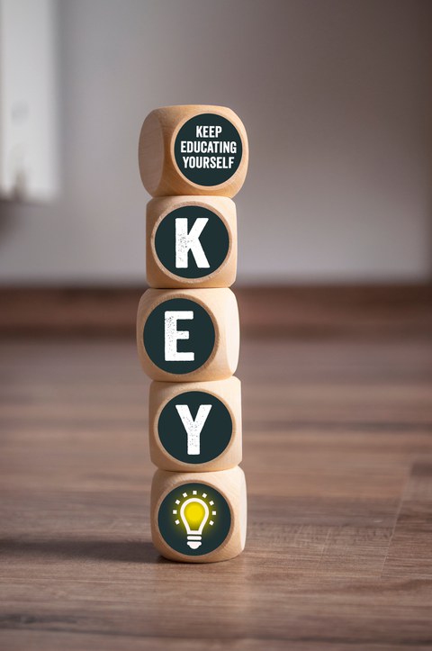 KEY Keep Educating Yourself on wooden background