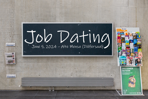 Wall with blackboard and newspaper rack in the lecture hall center of TU Dresden, flyer stand in front of it; on the blackboard: "Job Dating June 5, 2025, Alte Mensa (Dülfersaal)".