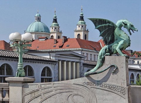 dragon statue in front of domed roofs
