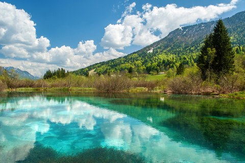 turquoise lake next to a mountainside