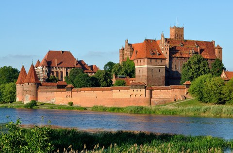 Great fortress built of bricks, with a river in the foreground