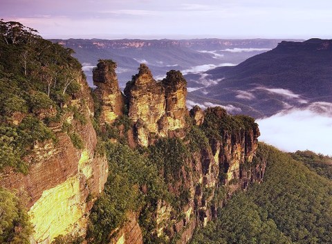 sandstone spires with wide forested valleys in the background
