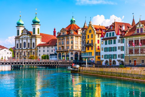 old town houses next to a turquoise river