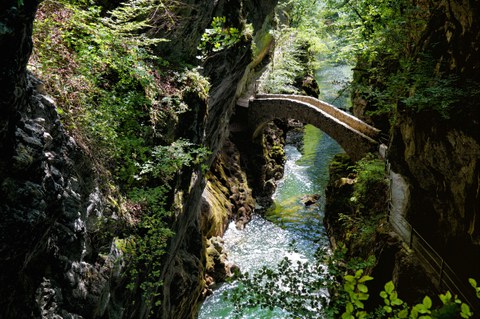 a small bridge spanning a river gorge