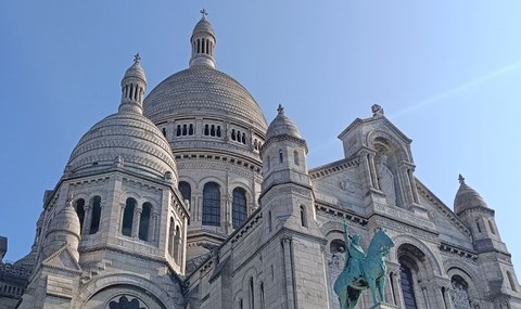 Historic white stone building with domes and towers