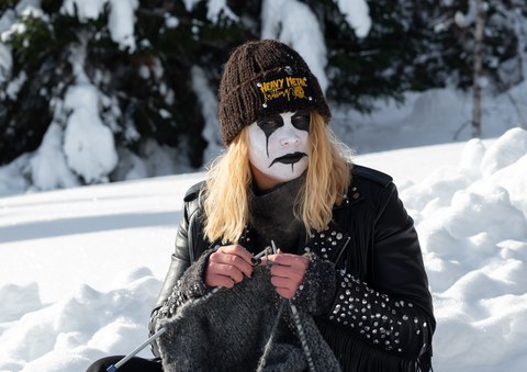 person in corpsepaint knitting