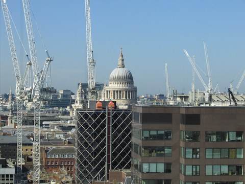 Dome of London's St. Paul's Cathedral, surrounded by more modern architecture and white building cranes
