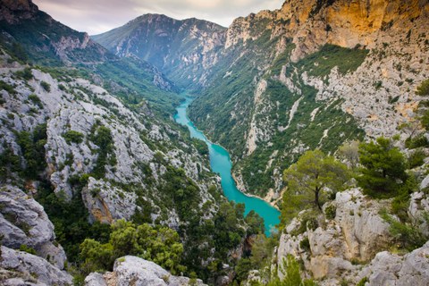 Mediterrane Berglandschaft, durch die ein türkisblauer Fluss fließt