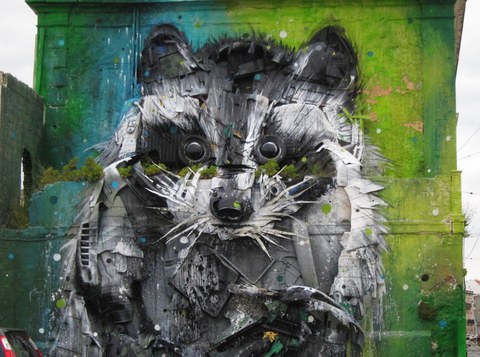 street art showing a detailed, three-dimensional portrait of a raccoon