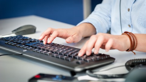 Employee types on the keyboard