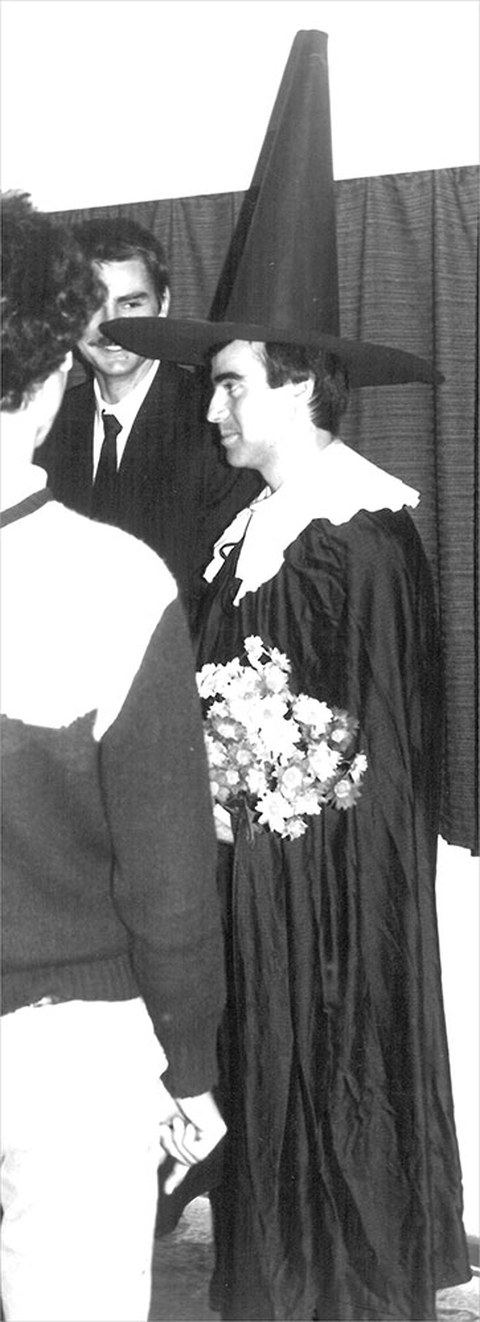 This black-and-white photo shows Hartmut Freitag receiving his graduate cap.