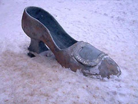 The photo shows a statue of cinderella's shoe.
