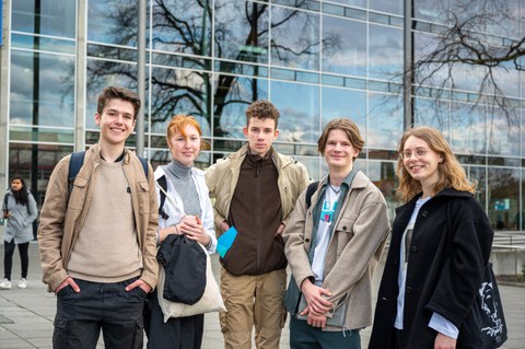 Gruppenfoto von fünf Jugendlichen vor Glasfront des Hörsaalzentrums.