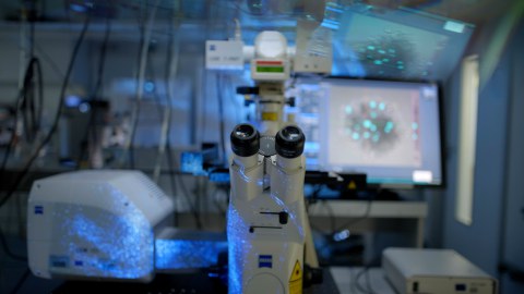 Close-up of a modern Zeiss microscope in a darkened laboratory