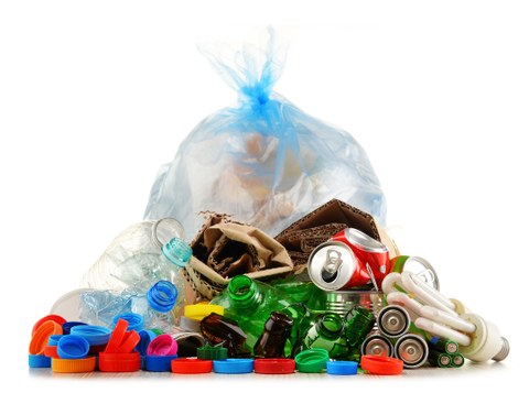 The photo shows recyclable waste consisting of glass, plastic, metal and paper.